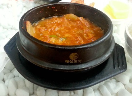 Kimchi jjigae is served bubbling hot in a stone dish and usually comes with rice (helps with the heat).