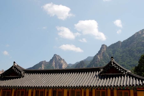 Korean rooftops and craggy peaks.