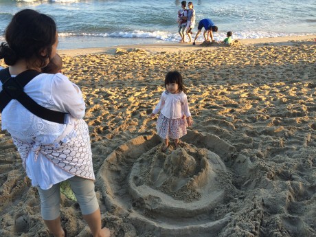 This little girl really wanted to destroy our sand castle. It was adorable.