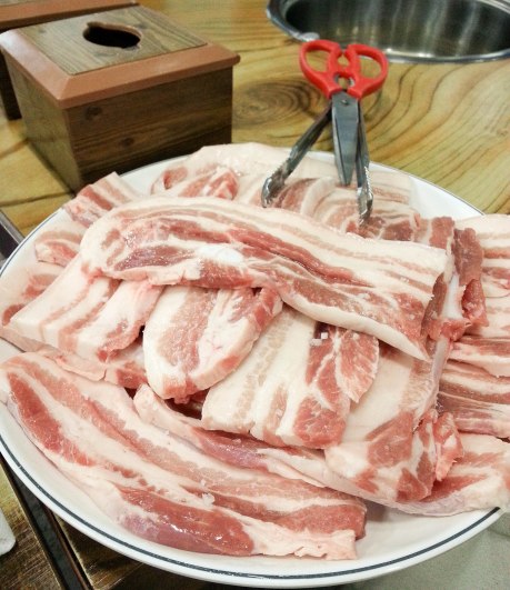 When ordering samgyeopsal, it's served raw for you took cook on the grill at your table.