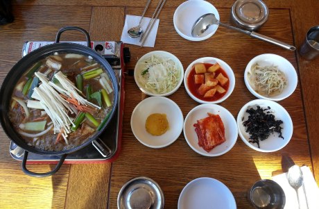 Bulgogi that is being pan-cooked at our table with traditional side dishes of cabbage salad, cubed radish kimchi, bean sprouts, mashed sweet potato, kimchi and dried seaweed. It was all delicious!